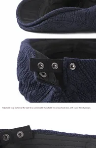 Detail view of the navy knit beret featuring an adjustable rear strap with three metal snaps