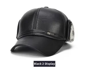 Detail view of winter leather baseball cap with grey faux fur ear flaps and metal logo