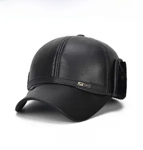 Close-up of black faux leather winter baseball cap with side metal sports badge