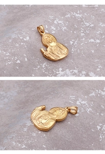 Macro view of gold religious Jesus Sacred Heart pendant in polished titanium steel