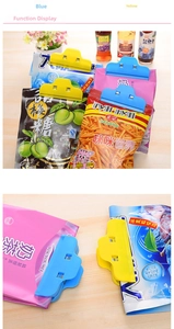 Close-up of colorful large plastic food clips sealing snack bags on a wooden table