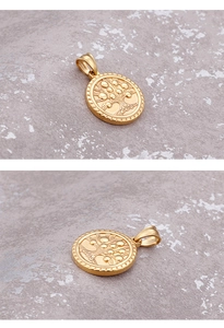Detail of golden oval tree of life pendant showing relief pattern on grey stone