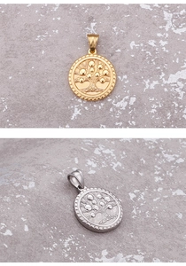 Detailed relief of gold and silver tree of life pendants on a grey stone background