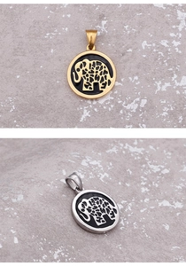 Close-up of elephant pendants in gold and silver finishes on a textured stone surface
