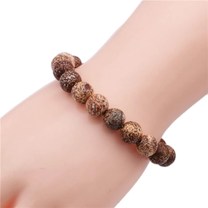 Detail of 10mm natural map stone beaded bracelet showing unique matte spotted textures