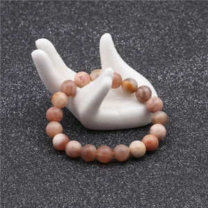 Detailed macro view of 10mm natural stone beads with orange and grey textures