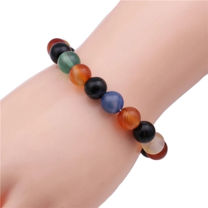 Close-up of 10mm natural stone beads on elastic bracelet with colorful agate and malachite