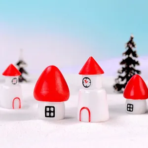 Miniature red and white Christmas resin houses on a snowy landscape background