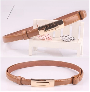 Detail of camel patent leather thin belt with light gold square buckle for dresses