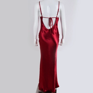 Detail of red satin backless maxi dress featuring thin cross straps and elegant silhouette