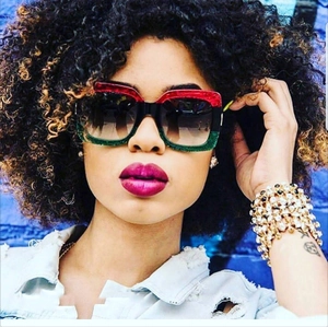 Close-up of retro square sunglasses with red green black glitter frames on model