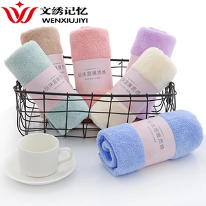 Detail of coral fleece towels in six pastel colors stored in a black metal basket