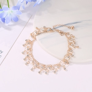 Elegant gold-tone layered anklet with sparkling rhinestones and delicate tassel charms