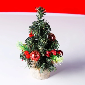 Close-up of a 20cm mini Christmas tree with red baubles and a rustic burlap base