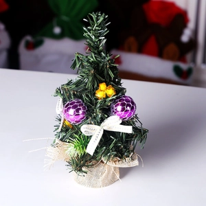 Detailed view of a 20cm mini Christmas tree with burlap base and purple ball ornaments