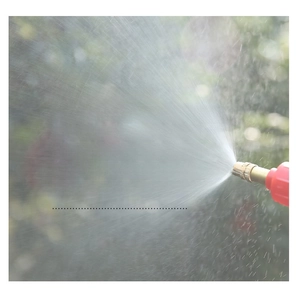 Detail of adjustable brass nozzle on red garden sprayer with fine misting effect