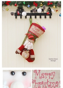 Detail of Santa Claus 3D doll and Merry Christmas embroidery on a red festive stocking
