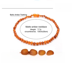 Macro detail of matte cognac Baltic amber beads on a 13-inch baby teething necklace