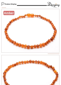 Detail view of natural Baltic fire amber beads with smooth texture for baby necklaces
