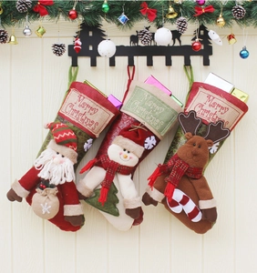 Detailed view of linen Christmas stockings with 3D Santa, Snowman and Reindeer figurines