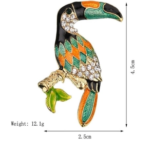Detail shot of enamel toucan brooch showing 4.5cm height and crystal branch detail