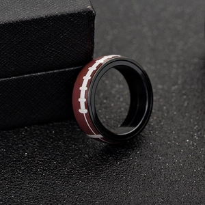 Detailed macro view of American football ring with red leather texture and white stitching