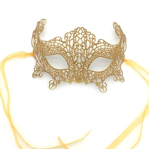 Detailed view of a golden lace phoenix masquerade mask with yellow satin ribbons