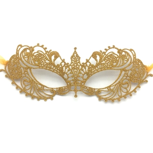 Detailed view of golden lace masquerade mask with intricate phoenix wing pattern