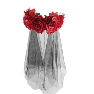 Detail of red fabric roses and black mesh veil on a Gothic style festival headband