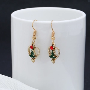Christmas tree heart earrings with green enamel and rhinestones on white ceramic cup