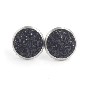 Detailed close-up of 12mm stainless steel stud earrings with shimmering black druzy inlay