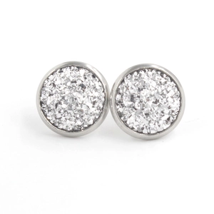Macro view of 12mm silver stainless steel stud earrings with shimmering druzy glitter texture