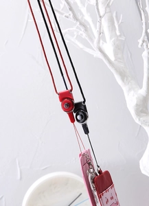 Detail of woven nylon lanyards with metal lobster clasps and cherry print PU leather card holders