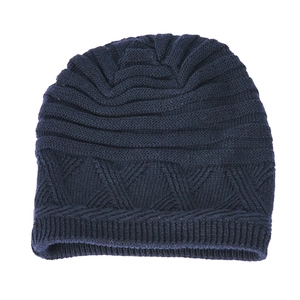 Close-up of deep blue winter knit beanie with geometric triangle pattern and ribbed hem