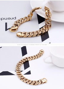 Close-up of gold Cuban chain links with micro-pave rhinestones and secure lobster clasp