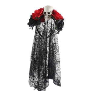 Detail of Halloween headband with skull decor, red roses, and black mesh lace veil