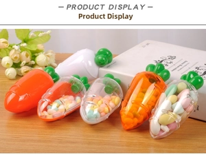 Detailed view of carrot-shaped candy containers in various colors on a wooden table