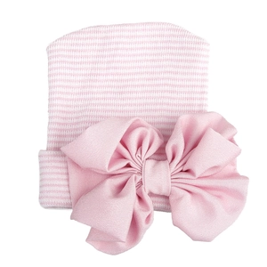 Detail of pink and white striped baby hat with a large decorative chiffon bow