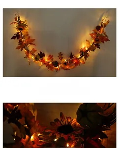 Close-up of autumn garland with warm LED lights, maple leaves, and mini pumpkins