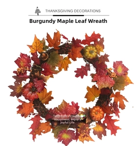 Detailed view of burgundy maple leaves and pumpkins on a rustic twig wreath base