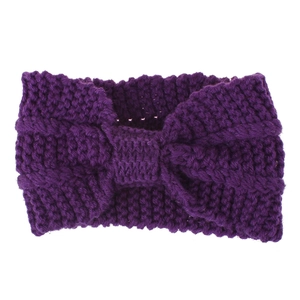 Detail of dark purple chunky knit ear warmer headband with central bow decoration