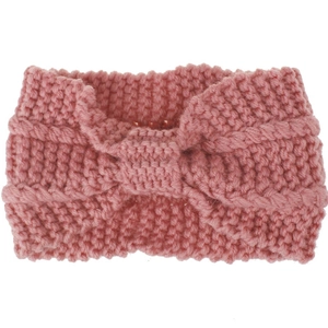 Detail of a pink knit headband featuring a bohemian twisted knot and soft wool texture