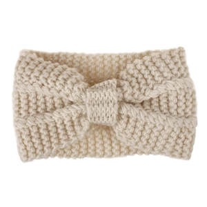 Detailed close-up of thick beige knit texture and bow knot on the winter headband