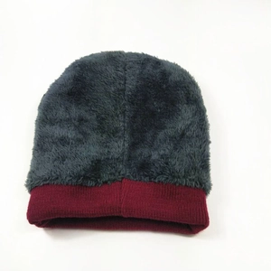 Detail of grey plush winter beanie with contrasting burgundy knitted ribbed cuff