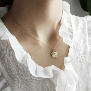 Elegant 925 sterling silver gold moon and sun pendant necklace on a female model