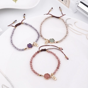 Detail of 4mm pink stone handmade beaded bracelets with engraved Hand Made charm