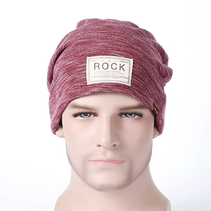 Close-up of knit texture and embroidered ROCK patch on a burgundy winter beanie