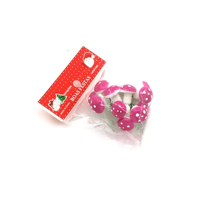 Close-up of pink artificial Christmas mushroom ornaments in clear plastic bag packaging