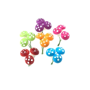 Macro detail of colorful miniature Christmas mushrooms with white dots on white background