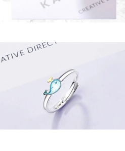 Macro shot of a blue whale open ring featuring light blue enamel and gold detail